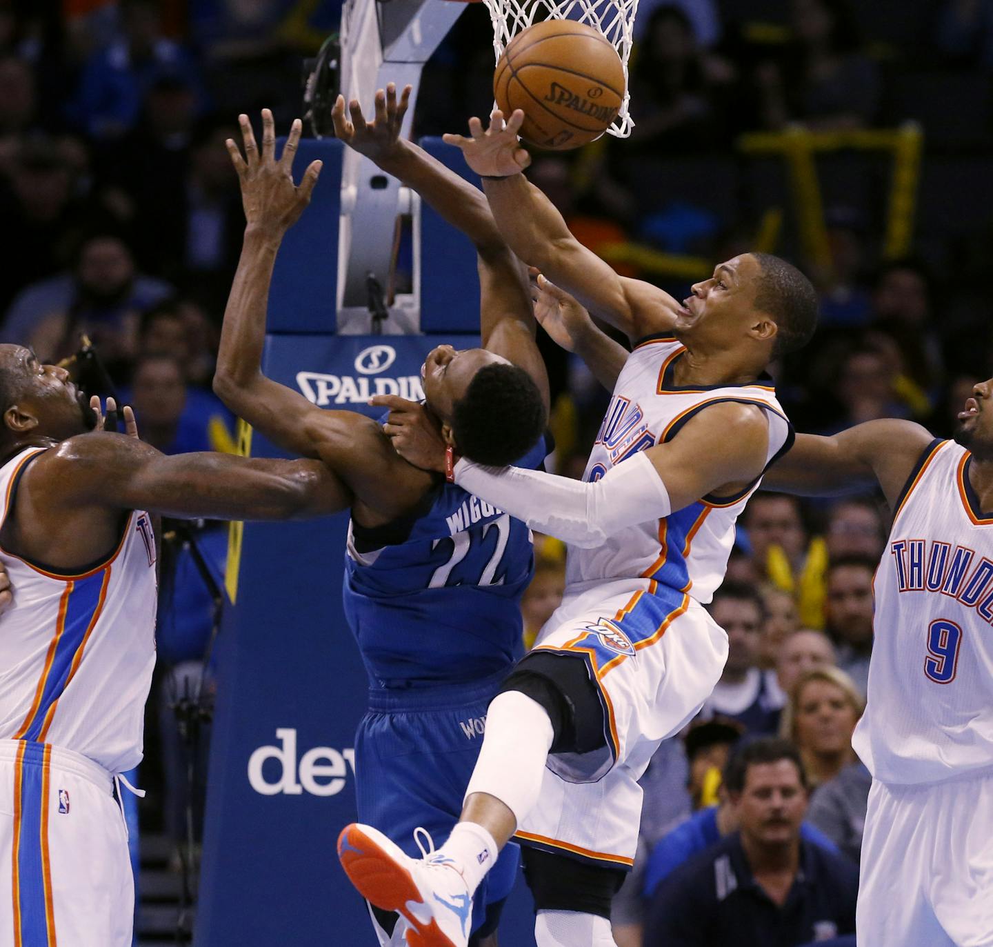 Minnesota Timberwolves forward Andrew Wiggins (22) loses the ball as he shoots while defended by Oklahoma City Thunder center Kendrick Perkins, left, Oklahoma City Thunder guard Russell Westbrook, center, and Oklahoma City Thunder forward Serge Ibaka (9) in the fourth quarter of an NBA basketball game in Oklahoma City, Monday, Jan. 26, 2015. Oklahoma City won 92-84. (AP Photo/Sue Ogrocki)