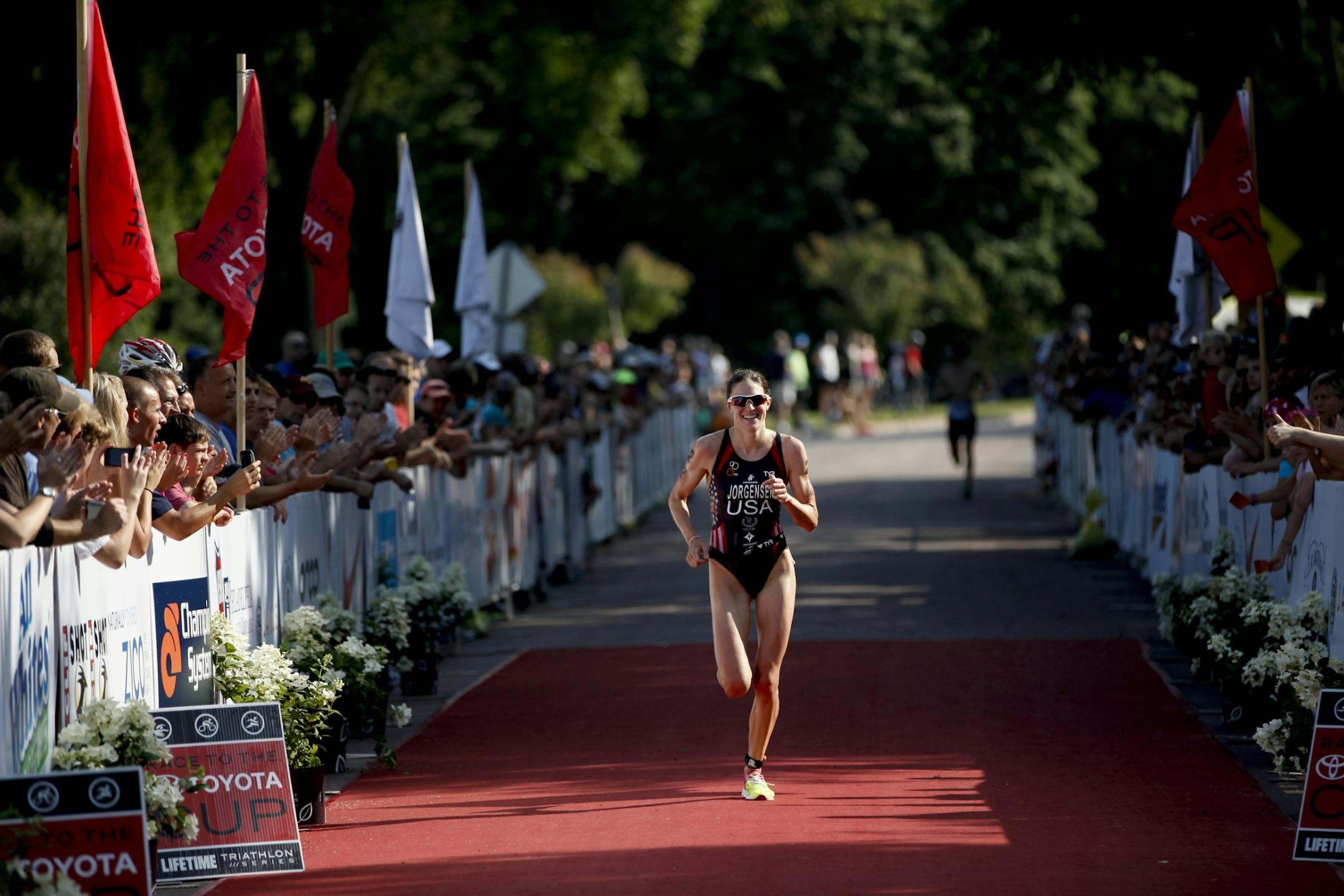 Gwen Jorgensen approaches the finish line crossing in second place for the pro-women's at the Lifetime Fitness Triathlon at Lake Nokomis Minneapolis, Minn. on Saturday, July 14, 2012.