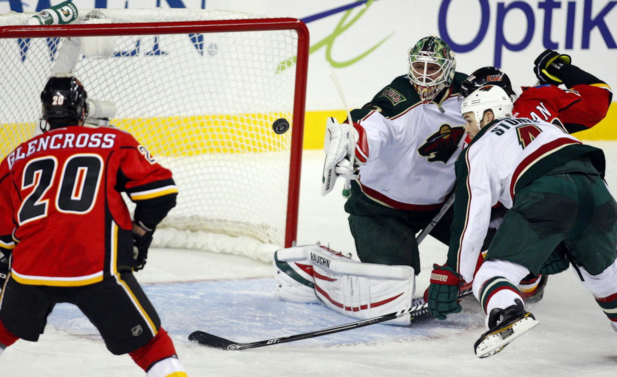 Wild goalie Niklas Backstrom and Clayton Stoner, right, watched the puck as they defended against Calgary's Curtis Glencross.