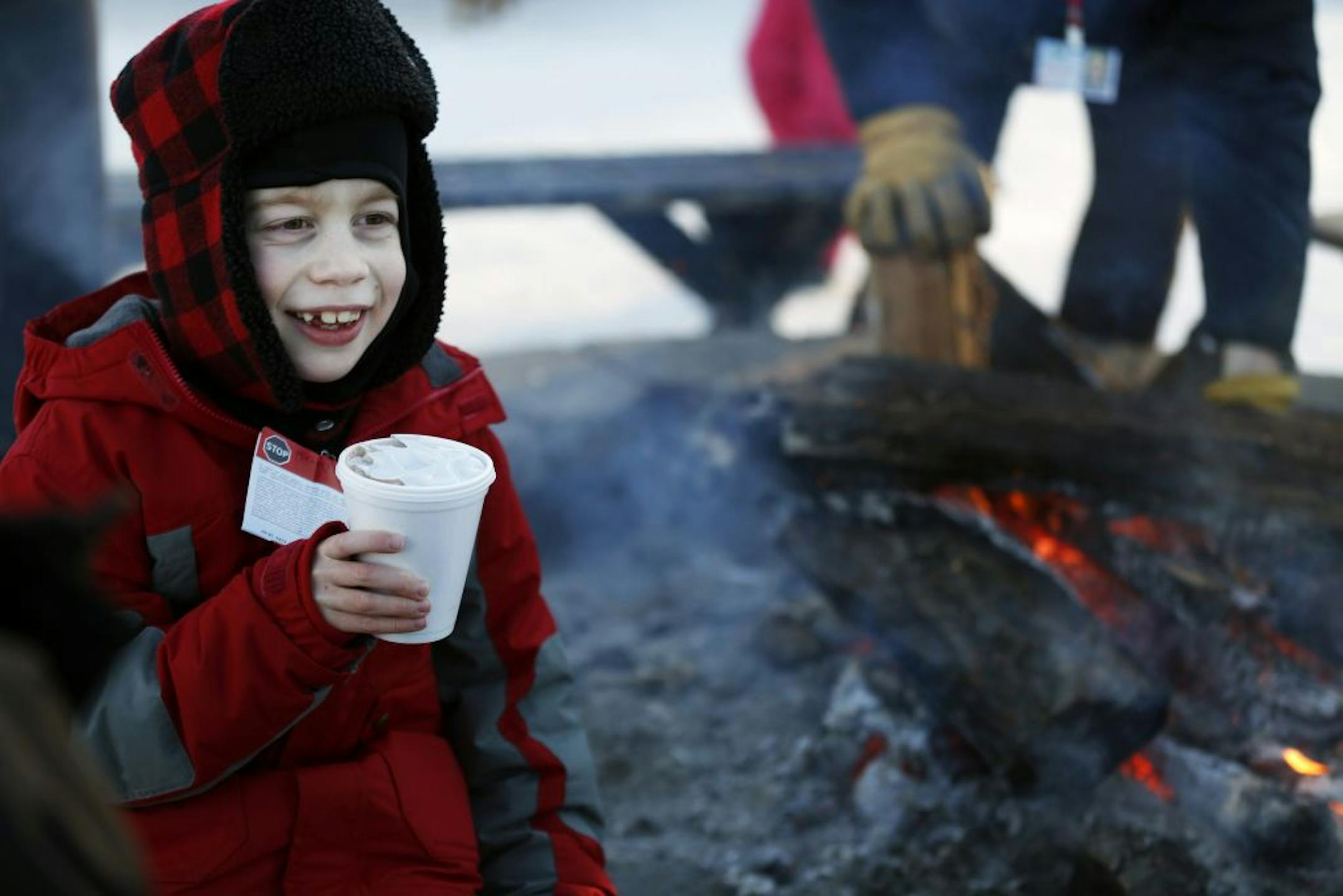 Hot chocolate and a camp fire near the snowtubing hill at Buck Hill were just the right combination for Zachary Asher, 8, of Eden Prairie. Zachary just moved to the Twin Cities from North Carolina, where temperatures Monday generally topped out in the 50s.