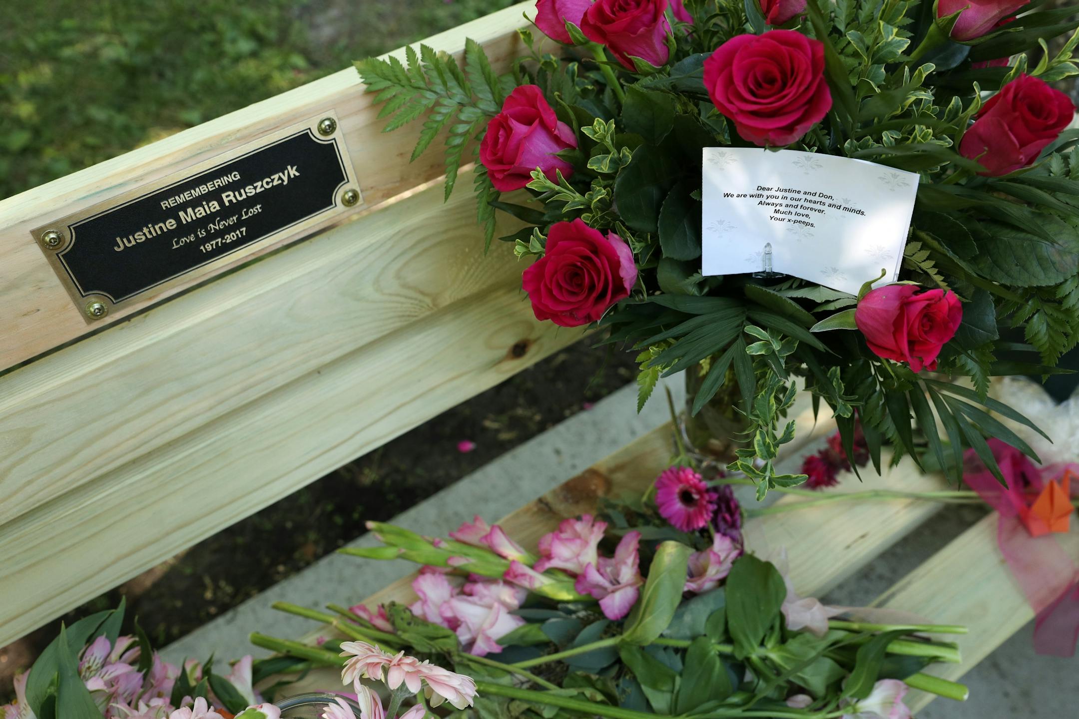 Flowers sat on a bench dedicated to Justine Ruszczyk Damond at Minnehaha Creek between 53rd and 54th streets on the one year anniversary of her death.