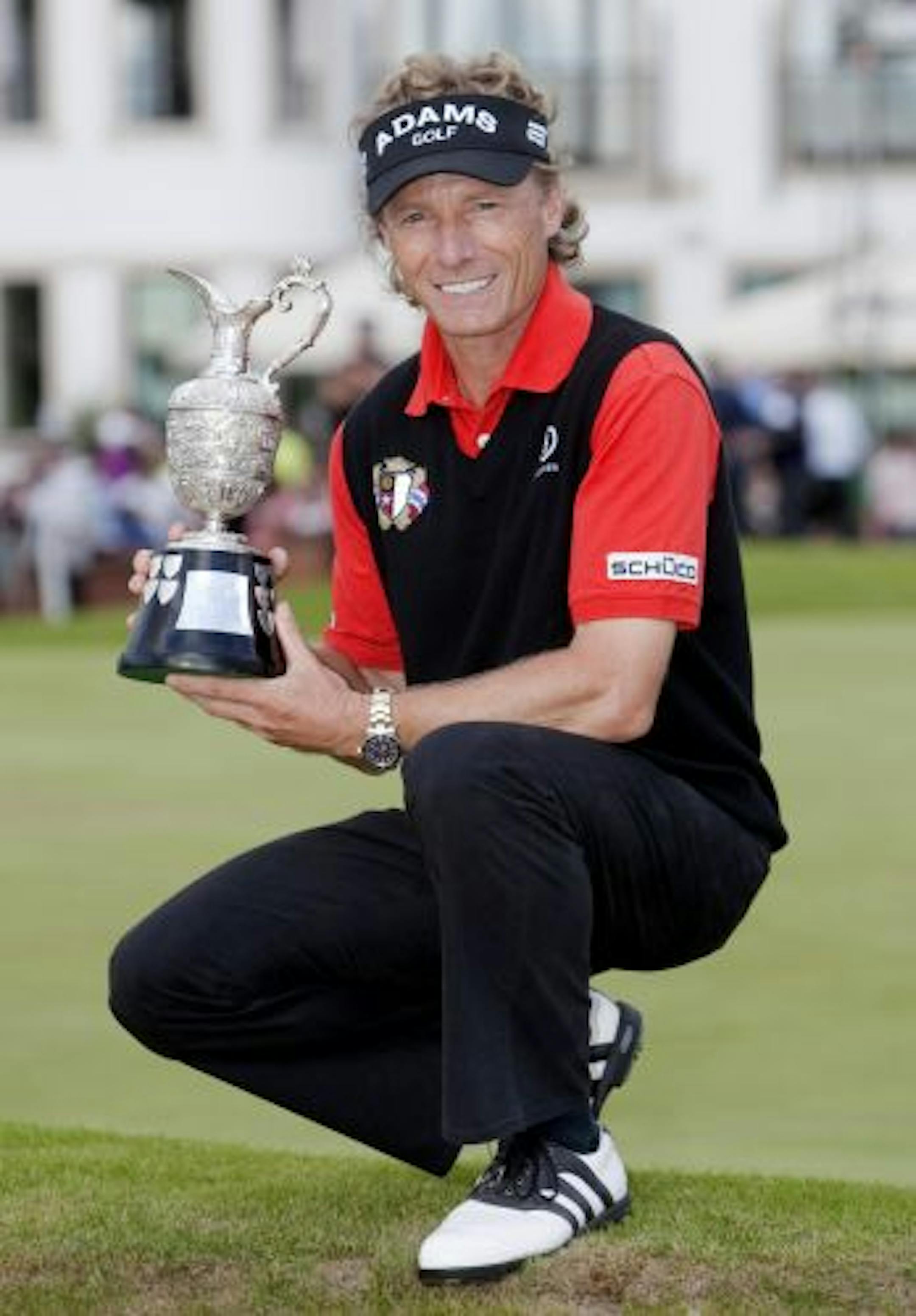 Germany's Bernhard Langer holds the trophy after winning the Fourth Round of the British Seniors Open at Carnoustie Golf Club, Carnoustie, Scotland Sunday, July 25, 2010.