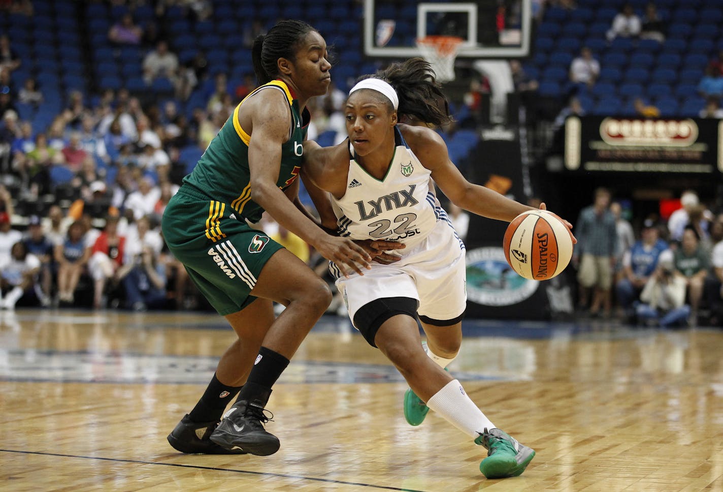 Minnesota Lynx guard Monica Wright (22) pushes the ball past Seattle Storm forward Victoria Dunlap in the first half of a WNBA basketball game Wednesday, June 6 2012, in Minneapolis.