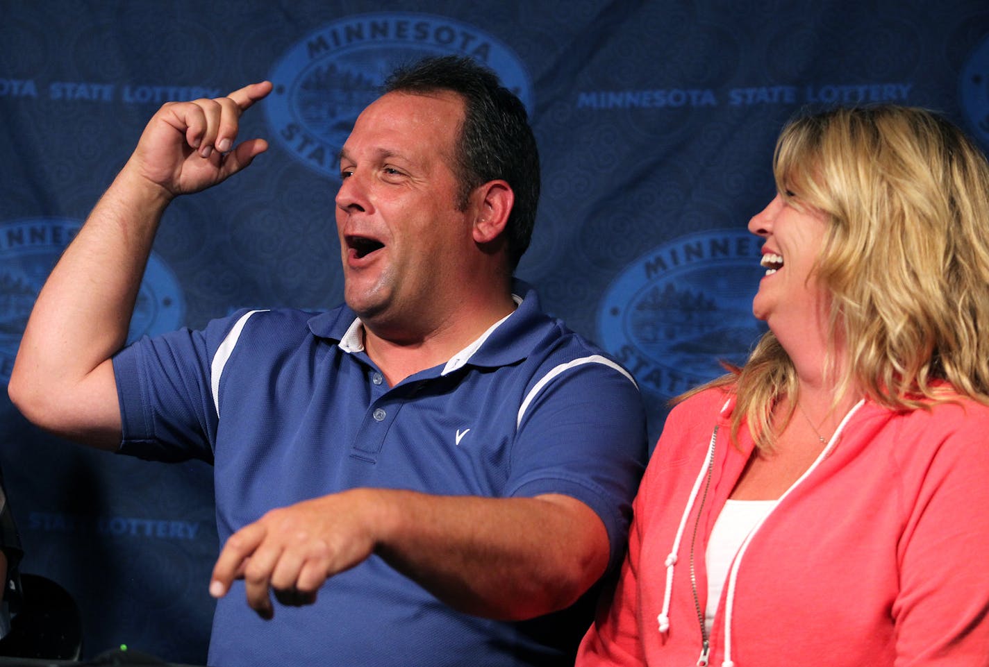 Paul White, of Ham Lake, with his significant other Kim VanReese, holds a press conference after claiming a $149.4 million Powerball jackpot at the Minnesota State Lottery office in Roseville, Minn., on Thursday, August 8, 2013. ] (ANNA REED/STAR TRIBUNE) anna.reed@startribune.com (cq)