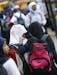 Two girls at Tarek ibn Ziyad Academy in Inver Grove Heights chatted as they walked to their bus. The school and the state Department of Education are 