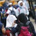 Two girls at Tarek ibn Ziyad Academy in Inver Grove Heights chatted as they walked to their bus. The school and the state Department of Education are 