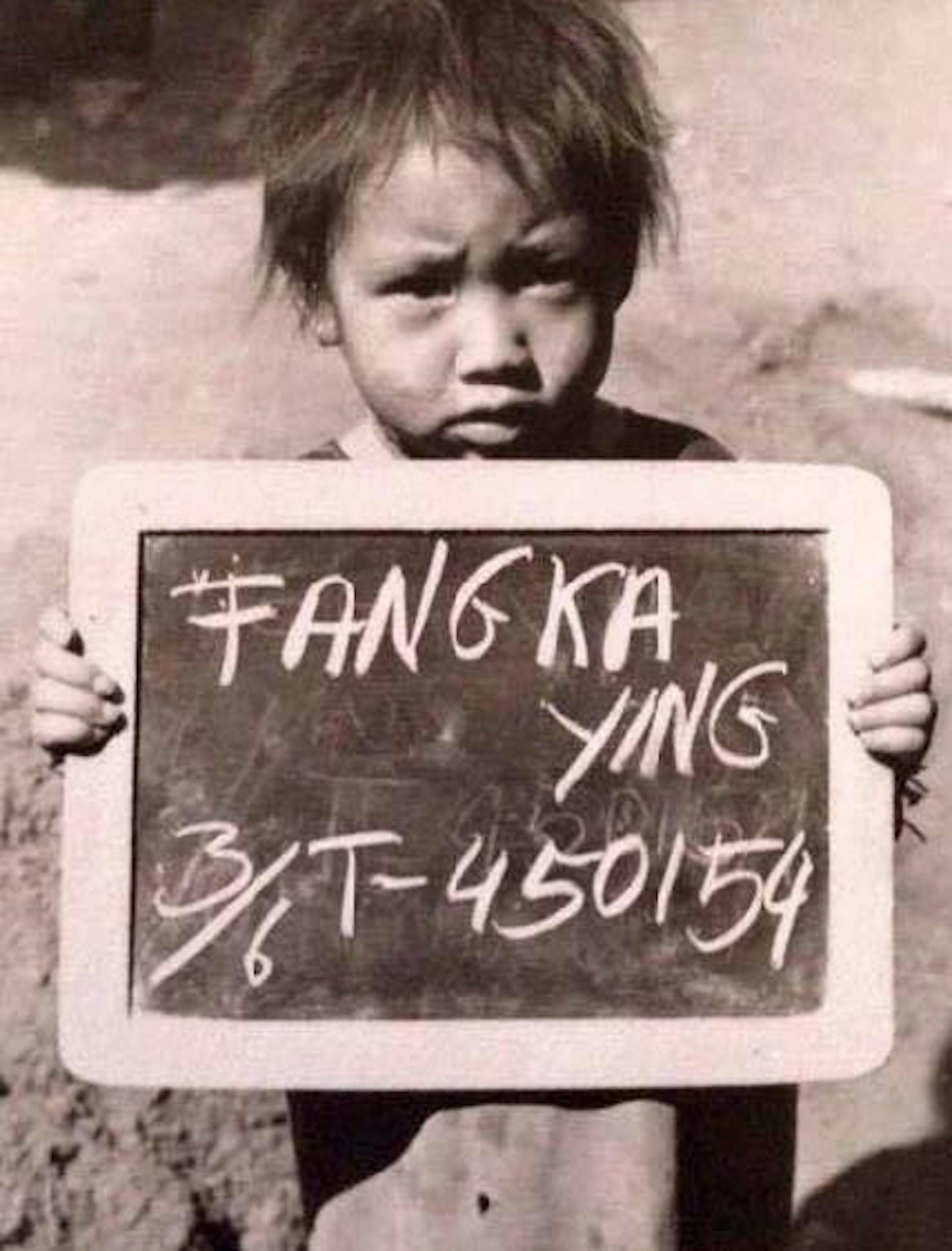 Susan Pha holds a sign with her name and a number assigned to her at a refugee camp in Thailand in 1980. She came to the United States as a refugee when she was 3 years old. ORG XMIT: 3DZQG0dVig82sIc536s_