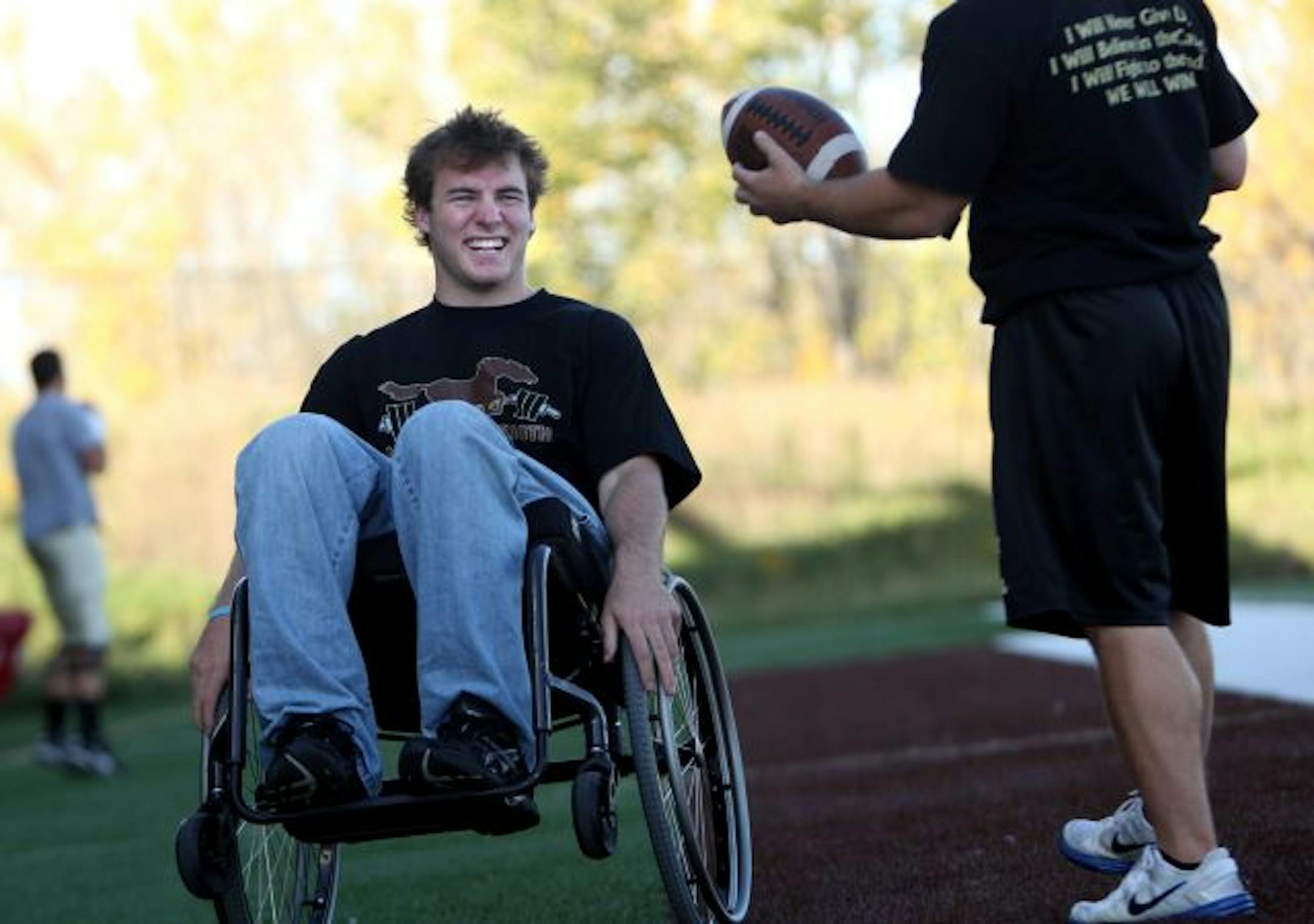 Derek Klinkner chatted with MSU's strength and conditioning coach Matt Paja on the sidelines during a recent practice. Klinkner broke his back in a farming accident this spring leaving him unable to walk. He still participates in the football team where he was a top defensive player.