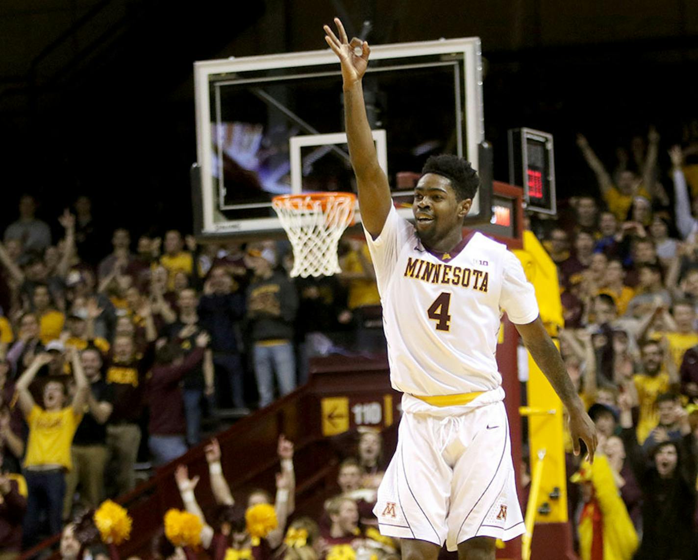 The University of Minnesota's Kevin Dorsey Jr. (4) signals a three after hitting a three-point shot in overtime and putting the U of M up by 6 during the University of South Dakota's 85-81 double overtime win at Williams Arena Saturday, Dec. 5, 2015, in Minneapolis, MN.