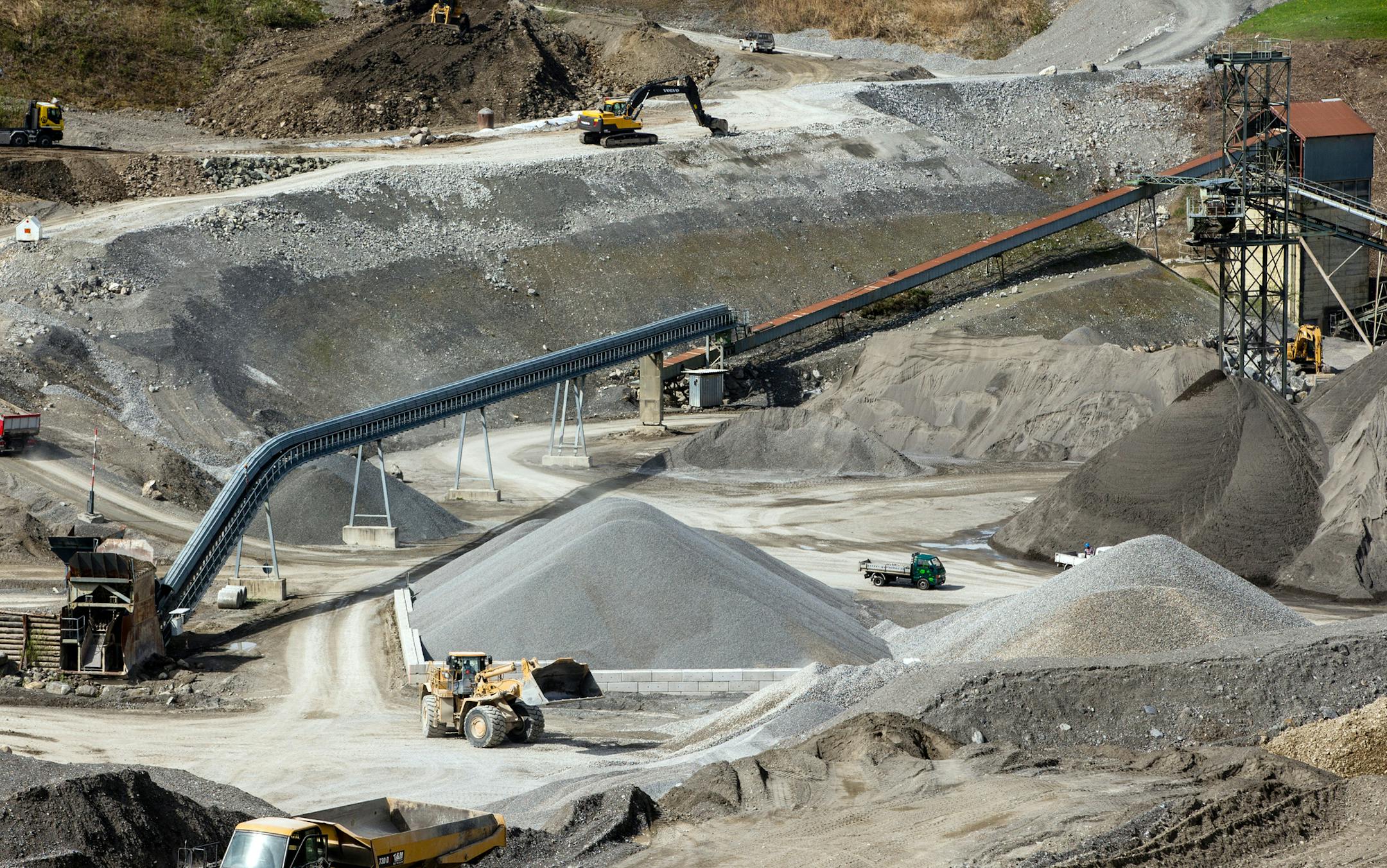 Tractors and excavators work in a stone quarry, operated by Holcim Ltd., in Oberdorf, Switzerland, on Monday, April 7, 2014. Holcim and Lafarge SA agreed a merger to create the world's biggest cement maker with more than $40 billion in sales and cut overcapacities and energy expenses. Photographer: Philipp Schmidli/Bloomberg ORG XMIT: 483548715