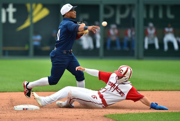 Second baseman Jorge Polanco (11) of the Minnesota Twins gets the force out on Whit Merrifield (15) of the Kansas City Royals as he throws to first in