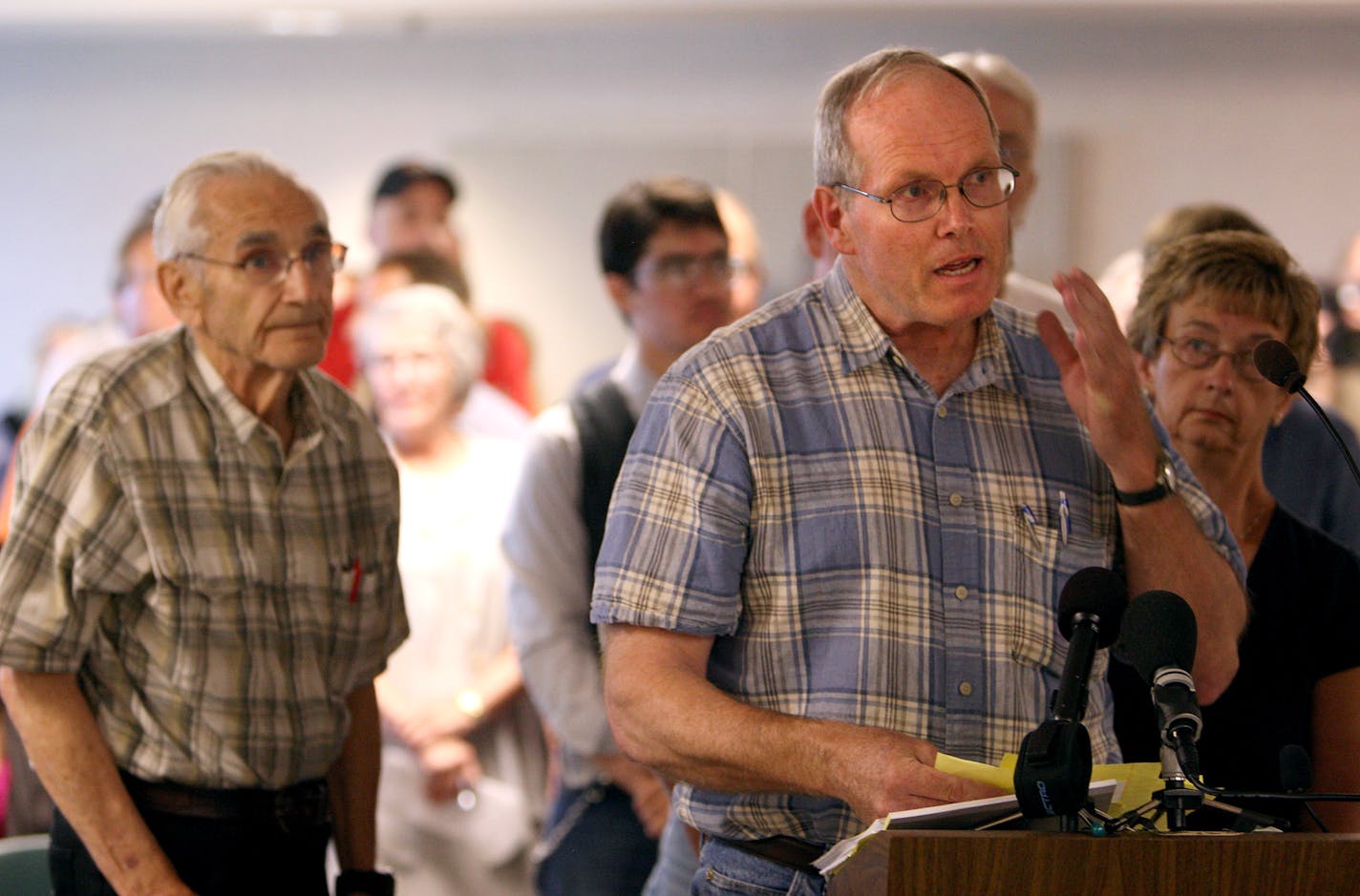 A line formed behind John Minge who spoke at the podium during a Town Hall meeting in Willmar on Friday afternoon.