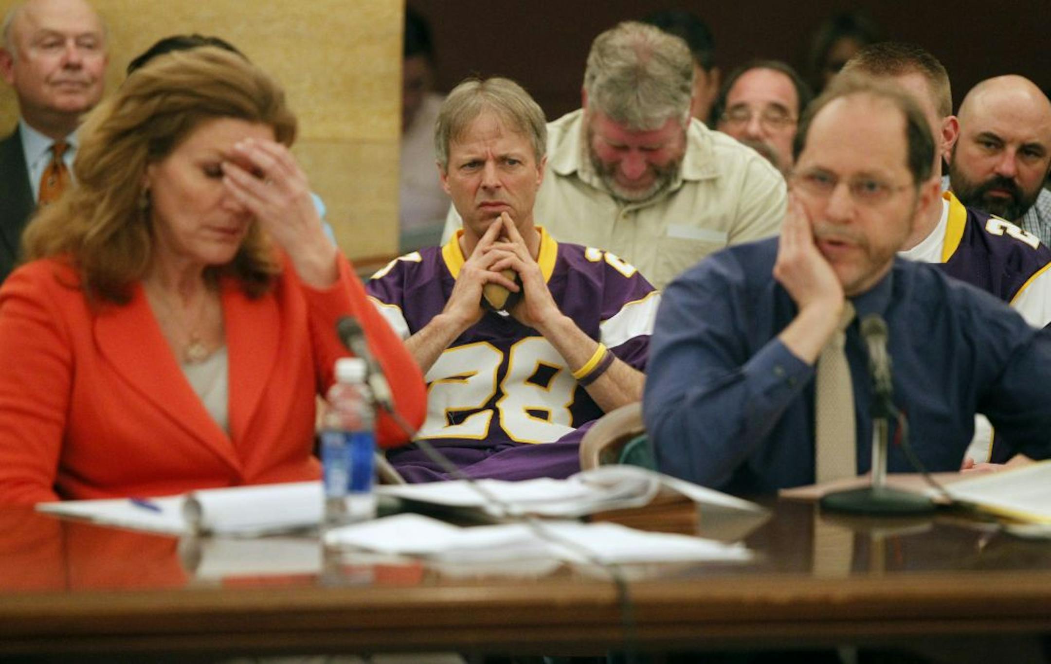 State Sen. Julie Rosen, left, and fan Larry Spooner reacted as Tom Goldstein, right, testified against the stadium plan.