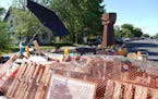 Photo by Renee Jones Schneider; A new barricade and a new fist sculpture are at the south and north entrance to George Floyd Square a day after part o