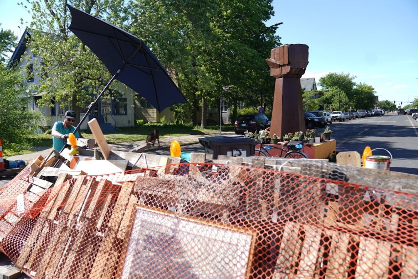 Photo by Renee Jones Schneider; A new barricade and a new fist sculpture are at the south and north entrance to George Floyd Square a day after part of the square was cleared in Minneapolis, Minn., on Friday, June 4, 2021.