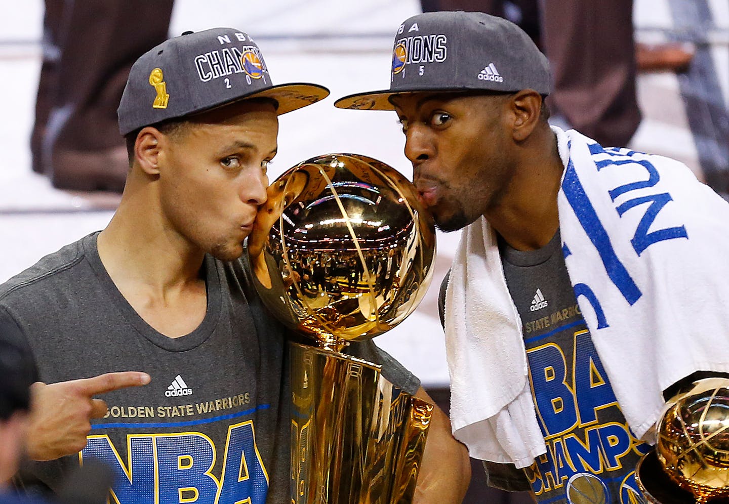 Stephen Curry, left, and Andre Iguodala kiss with the Larry O'Brien Trophy after defeating the Cleveland Cavaliers 105-7 in Game 6 of the NBA Finals on June 17.