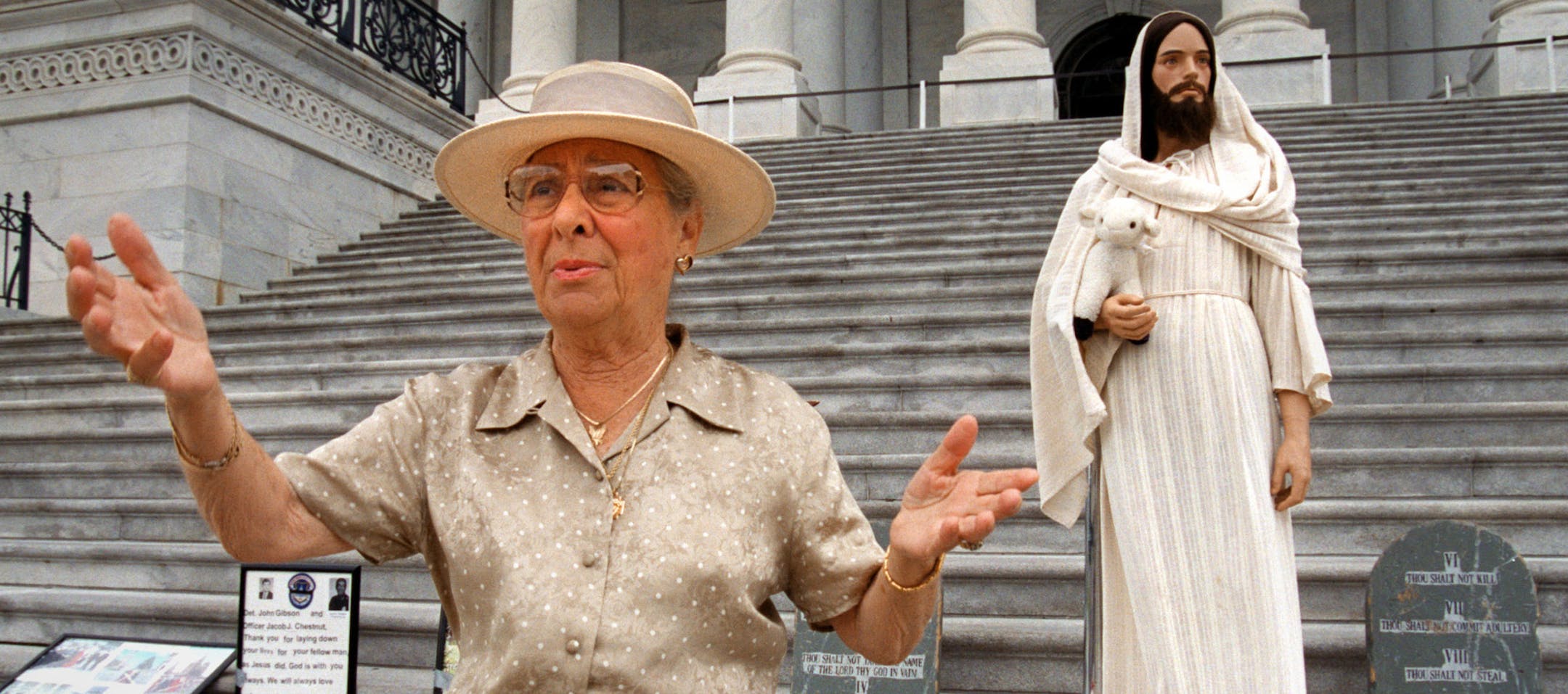 Rita Warren, of Virginia, raises her arms August 3, 2000 in praise, regarding Dick Cheney's speech at the Republican convention while standing on the steps of the Capitol Building. Warren, a committed faith activist more commonly known on Capitol Hill as Jesus Lady, died Sept. 1 at the age of 92. (Ken Cedeno/TNS) ORG XMIT: 1763687
