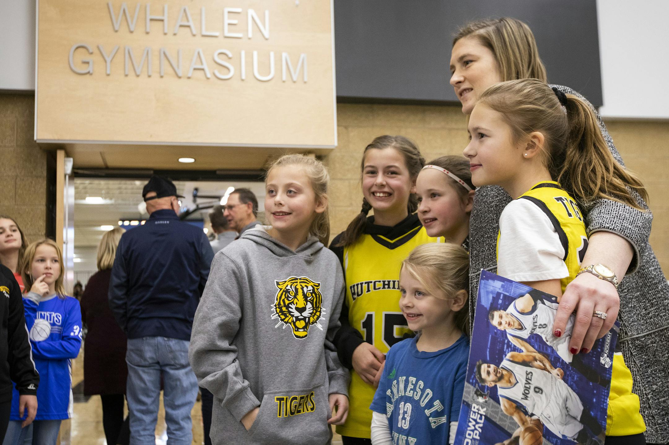 Lindsay Whalen and a group of young basketball players gathered for a photo near a Whalen Gymnasium sign on Tuesday night.