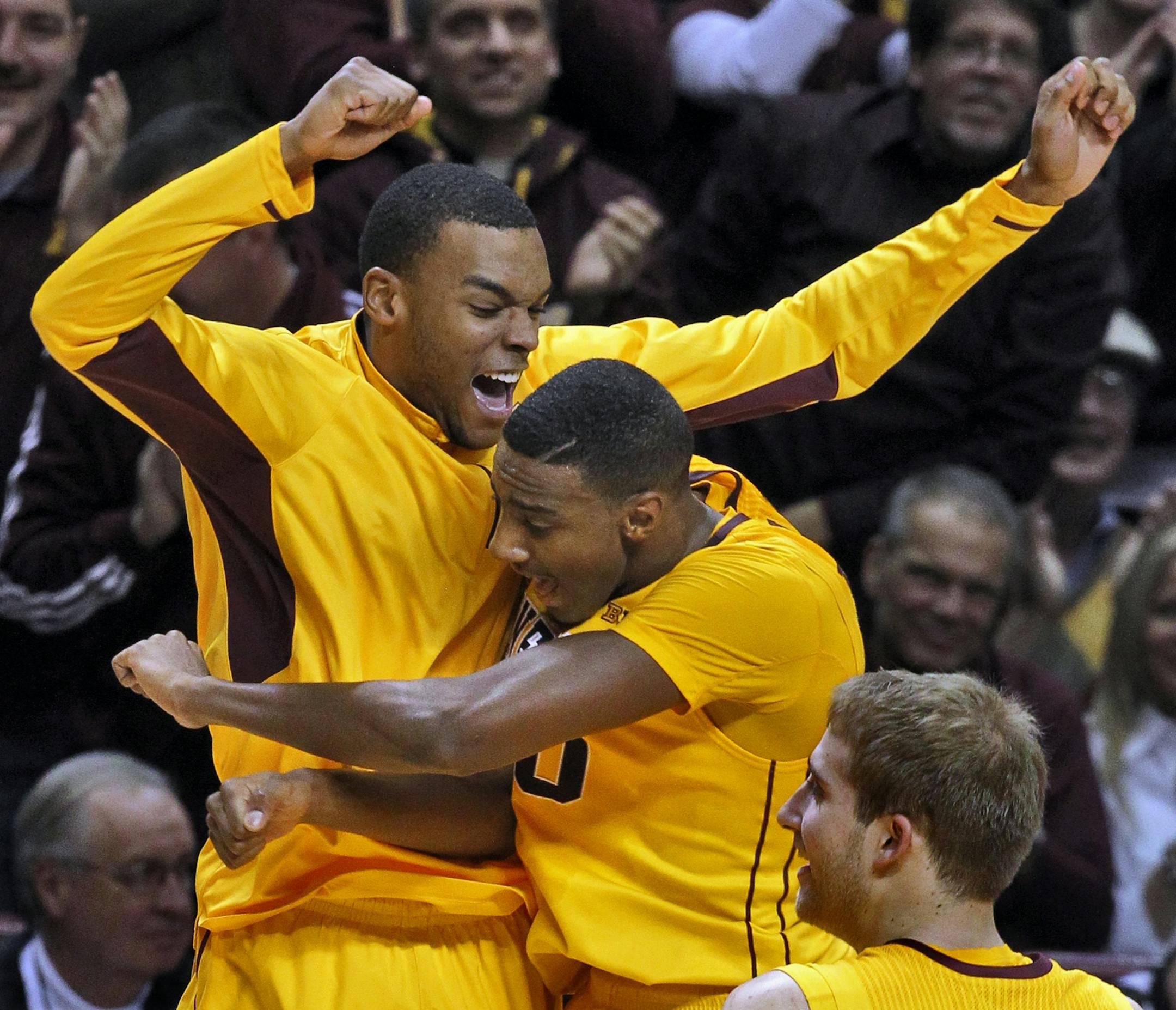 Andre Hollins, left, and Austin Hollins celebrate during the Gophers' victory over Northwestern.