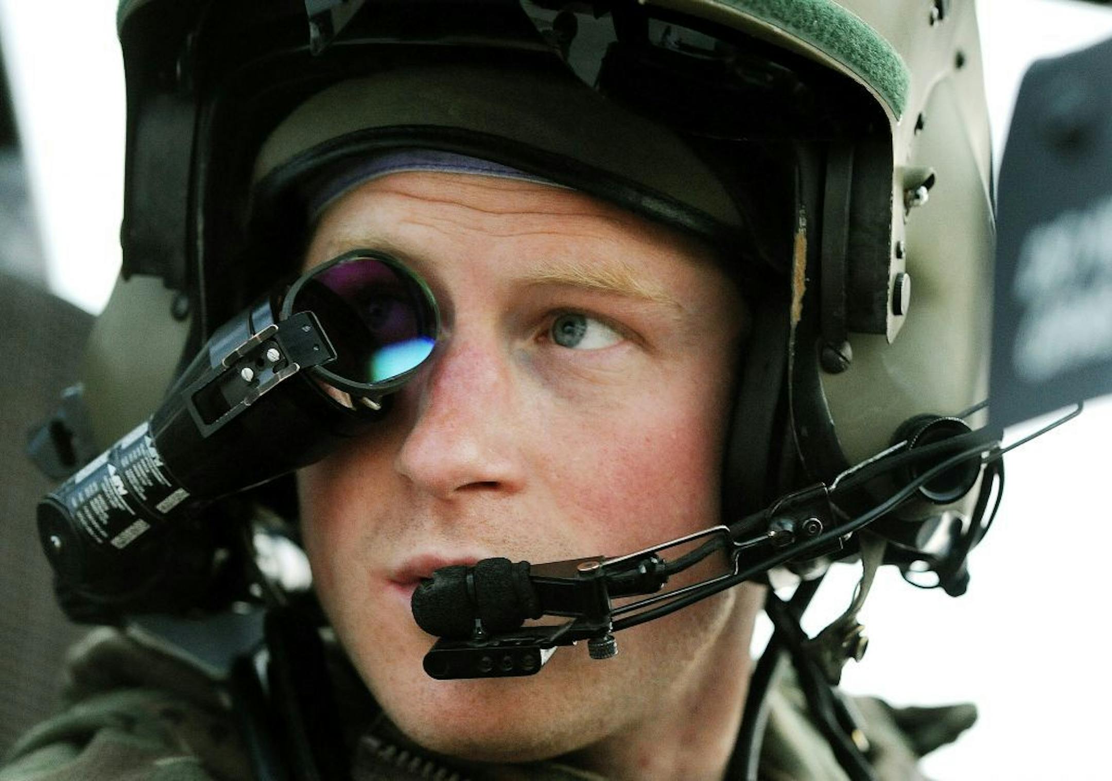 In this photo taken Dec. 12, 2012 and made available Monday Jan. 21, 2013 Britain's Prince Harry or just plain Captain Wales as he is known in the British Army, wears his monocle gun sight as he sits in the front seat of his cockpit at the British controlled flight-line in Camp Bastion southern Afghanistan. The Ministry of Defense announced Monday that the 28-year-old prince is returning from a 20-week deployment in Afghanistan, where he served as an Apache helicopter pilot with the Army Air Cor