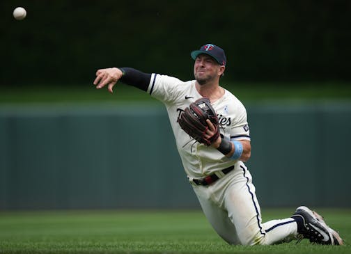 Minnesota Twins third baseman Kyle Farmer (12) fields a single by Detroit Tigers right fielder Jake Marisnick (15) in the third inning.