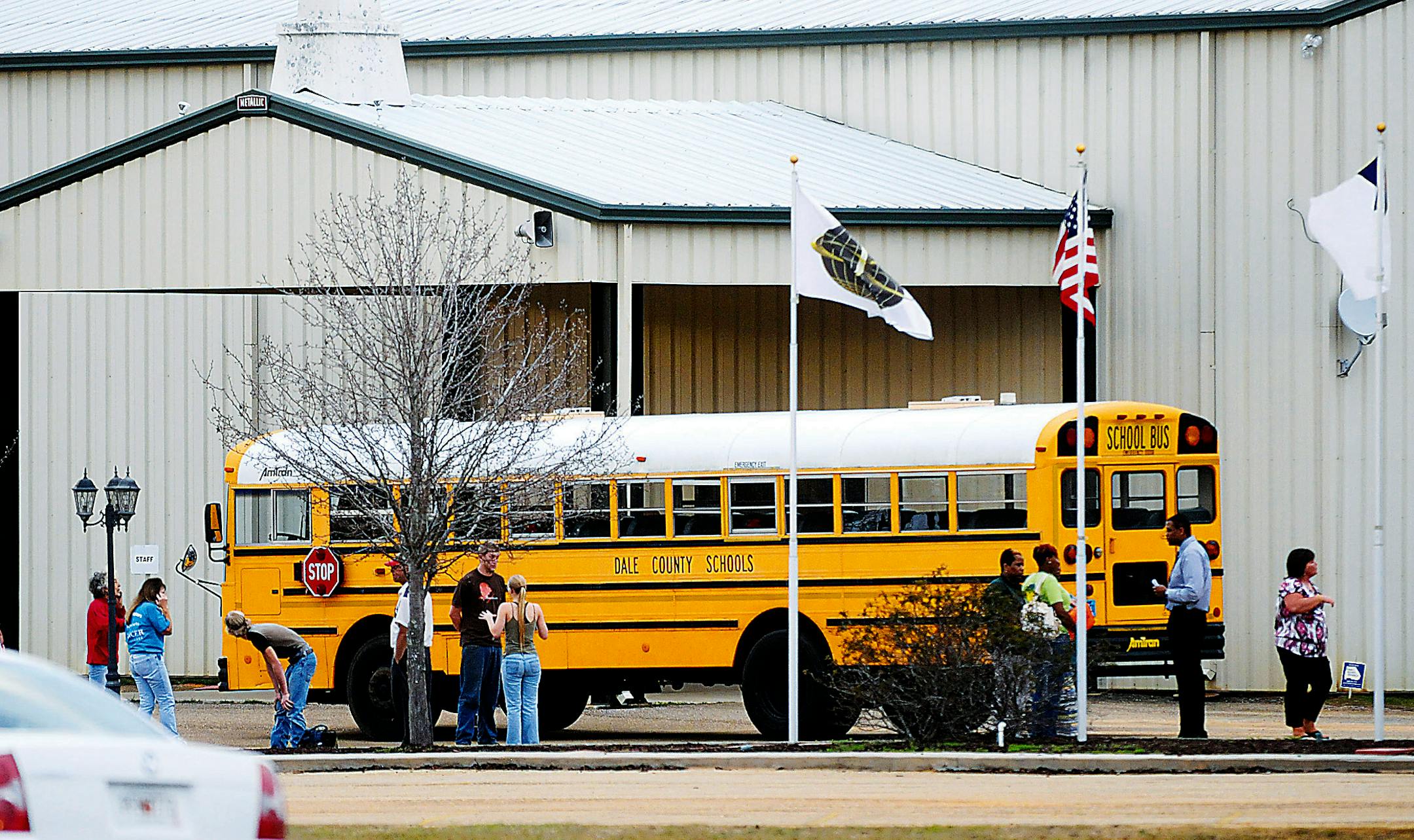 In this Tuesday, Jan 29, 2013 photo, residents look over the school bus where a shooting occurred near Destiny Church along U.S. 231, just north of Midland City, Ala. on Tuesday.