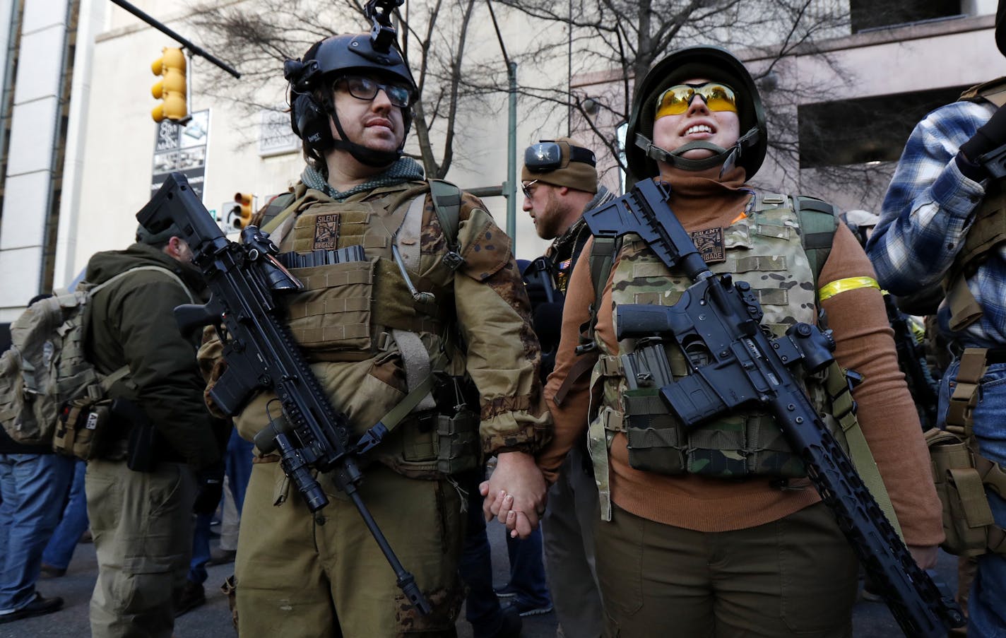 Demonstrators stand outside a security zone before a pro-gun rally, Monday, Jan. 20, 2020, in Richmond, Va. (AP Photo/Julio Cortez)