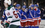 New York Rangers center J.T. Miller (10), second from right, celebrates his goal with teammates during the second period of the NHL hockey game agains