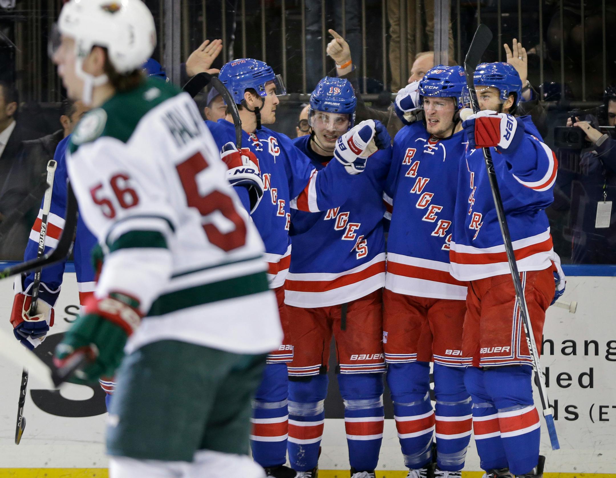 New York Rangers center J.T. Miller (10), second from right, celebrates his goal with teammates during the second period of the NHL hockey game against the Minnesota Wild, Thursday, Feb. 4, 2016, in New York. (AP Photo/Seth Wenig)