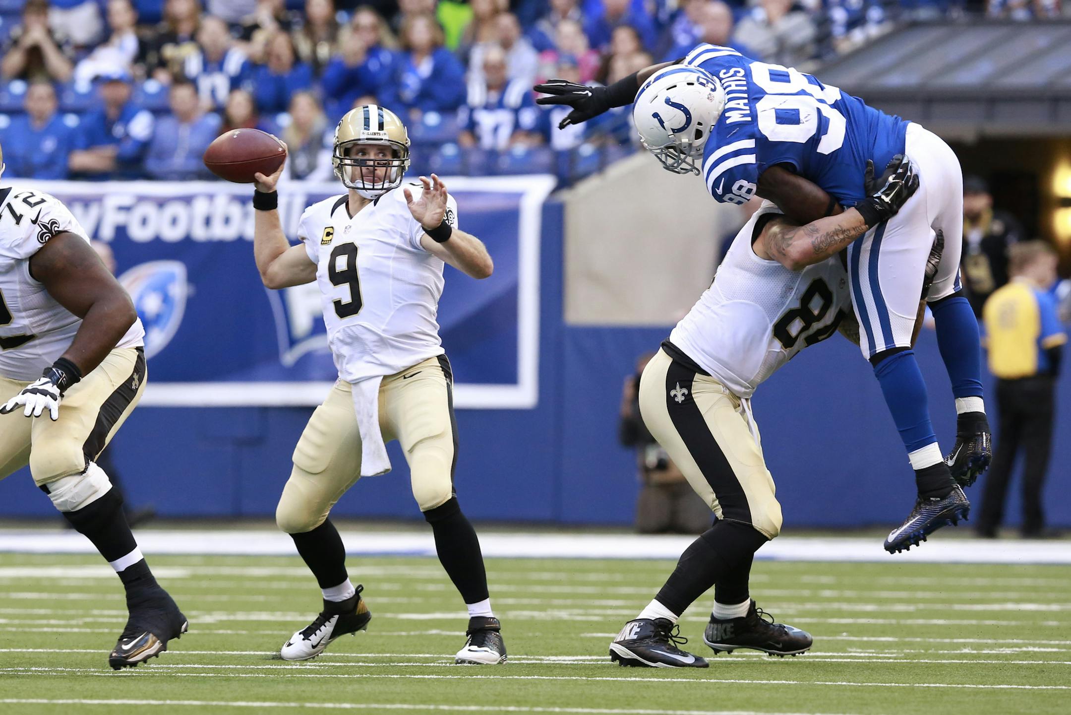 Indianapolis Colts outside linebacker Robert Mathis (98) is blocked by New Orleans Saints tight end Michael Hoomanawanui (84) to allow quarterback Drew Brees (9) to throw in the second half of an NFL football game in Indianapolis, Sunday, Oct. 25, 2015. The Saints defeated the Colts 27-21. (AP Photo/R Brent Smith) ORG XMIT: MIN2015111417204650