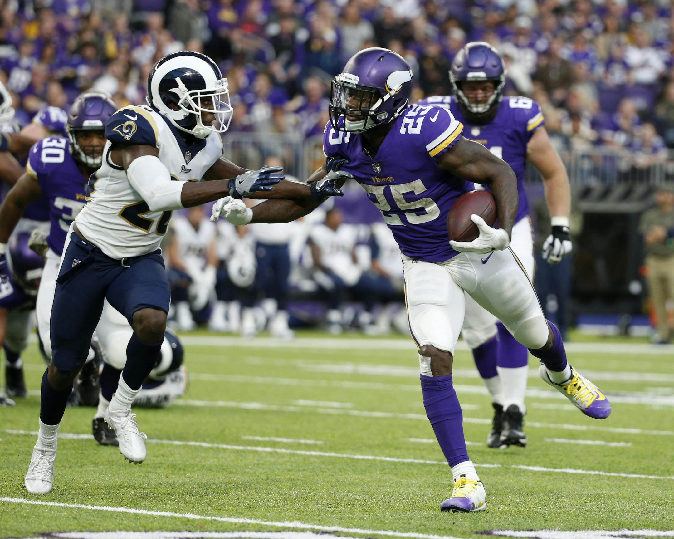 Minnesota Vikings running back Latavius Murray (25) runs from Los Angeles Rams free safety Lamarcus Joyner, left, during the second half of an NFL football game, Sunday, Nov. 19, 2017, in Minneapolis. The Vikings won 24-7. (AP Photo/Bruce Kluckhohn)