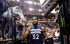 Fans slapped hands with Timberwolves center Karl-Anthony Towns (32) as he left the court Monday night. Towns had 29 points and 13 rebounds in the Wolv