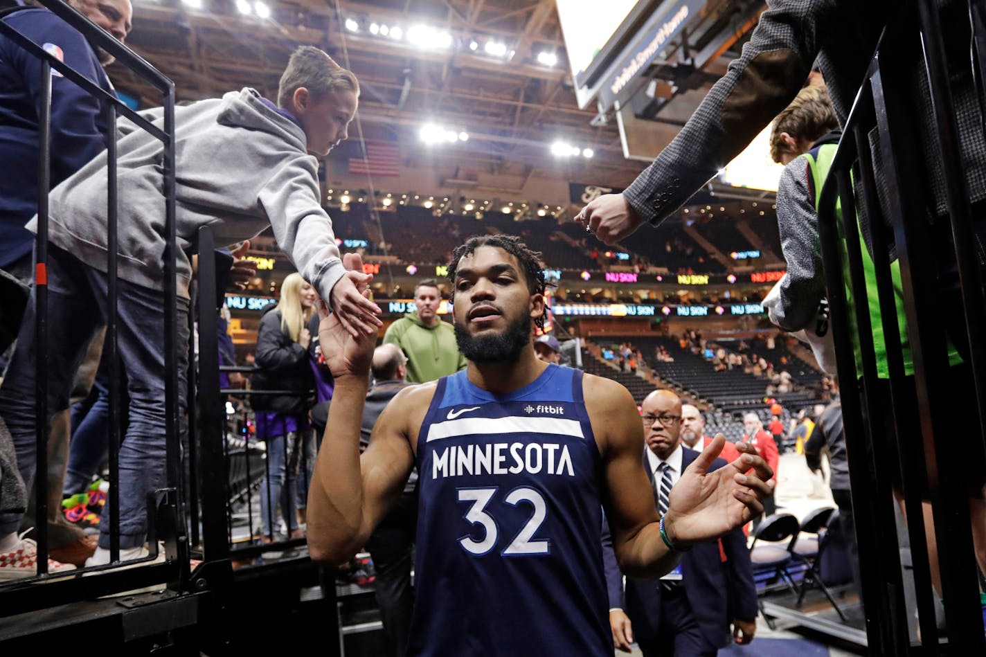 Fans slapped hands with Timberwolves center Karl-Anthony Towns (32) as he left the court Monday night. Towns had 29 points and 13 rebounds in the Wolves' 112-102 victory over the Jazz.