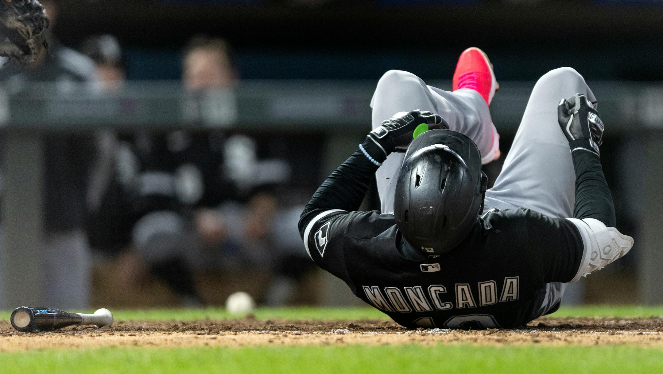 Yoan Moncada of the Chicago White Sox fell to the ground after fouling a ball off of his lower body in the ninth inning.