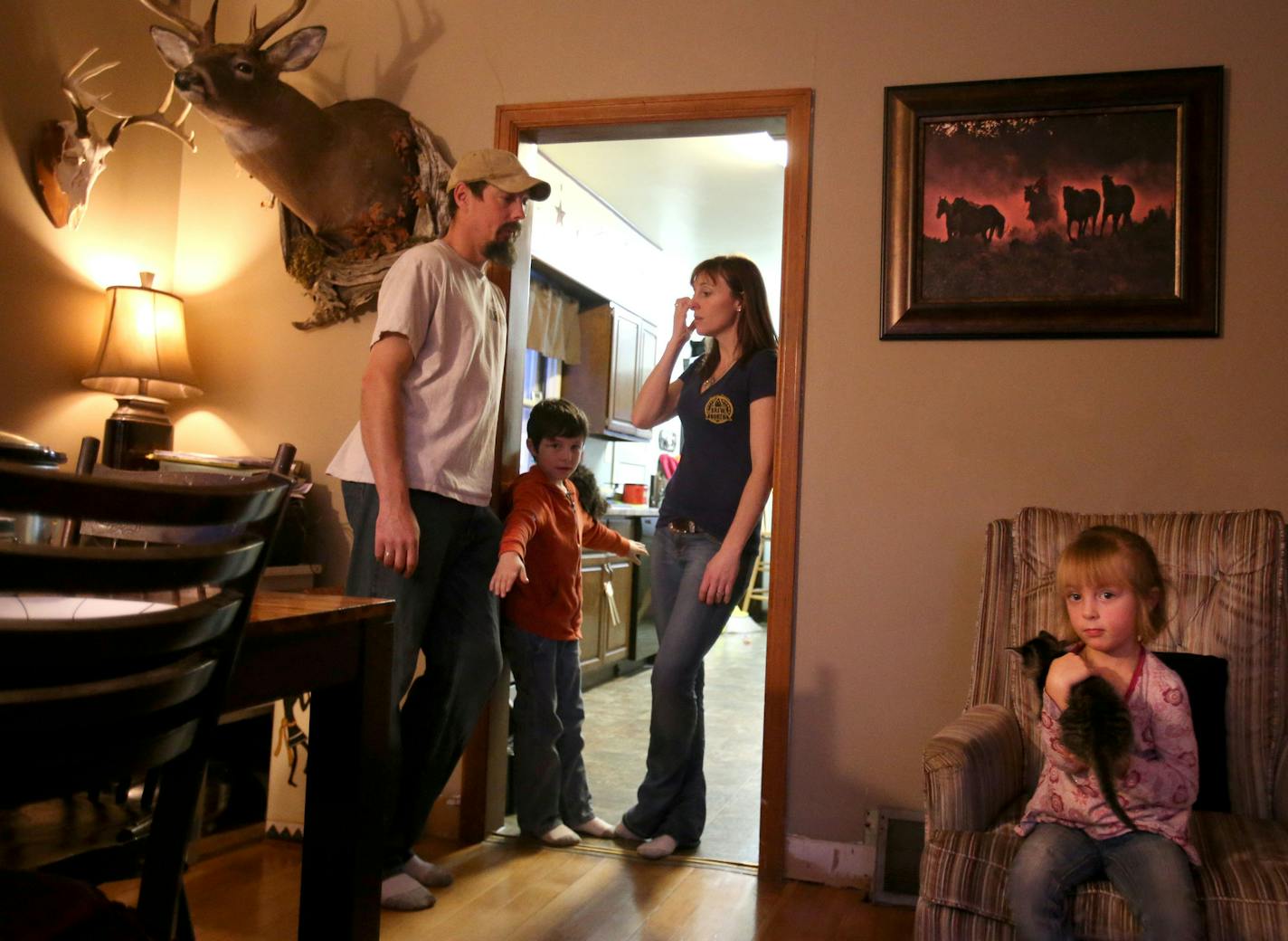 Dan Hill, left, was laid off at United Taconite in August and now the family relies on unemployment and the salary of his wife, Heather, a part-time LPN.