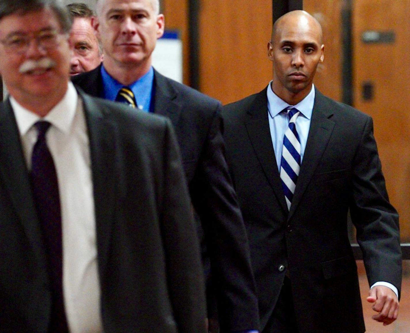 Former Minneapolis police officer Mohamed Noor, right, left court Thursday after testifying in his own defense.