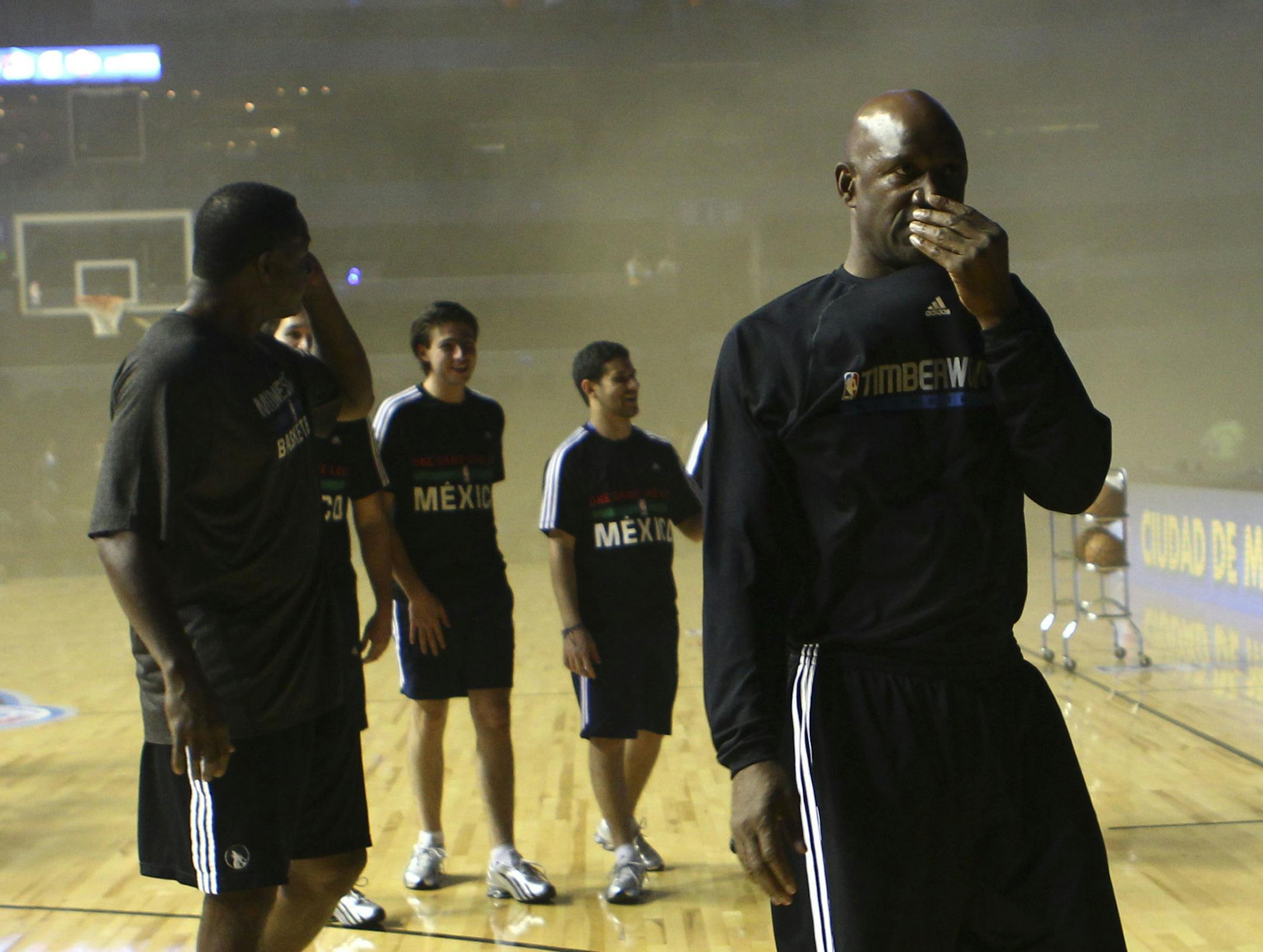 In this Wednesday, Dec. 4, 2013 photo, Minnesota Timberwolves basketball team walks off the Mexico City arena court in Mexico City. The arena was evacuated about 45 minutes before tipoff when a generator malfunction outside the arena sent smoke pouring into the building. The game between the San Antonio Spurs and Minnesota was postponed to be made up in Minnesota at a later date. (AP Photo/Christian Palma) ORG XMIT: WTW125