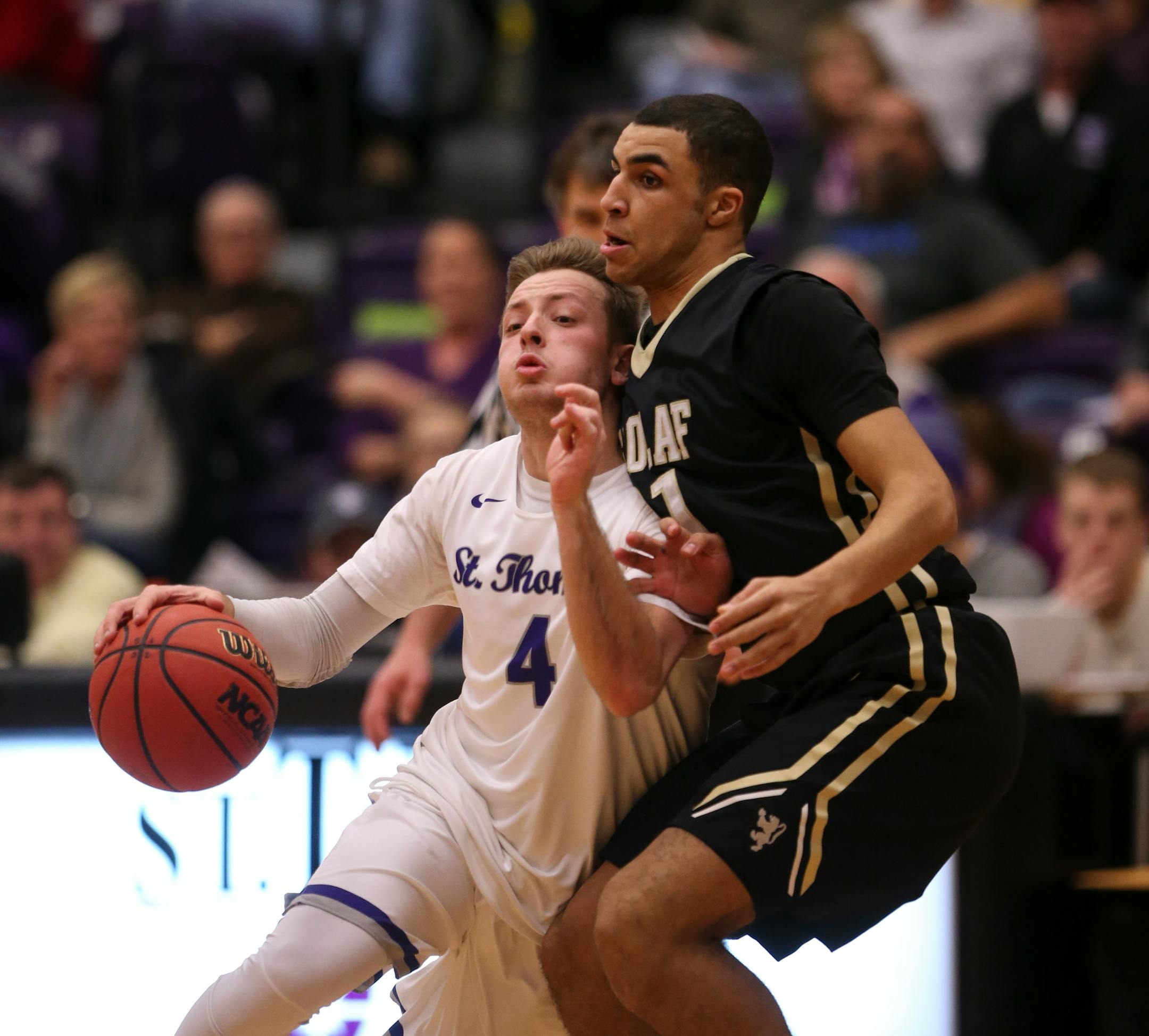 The Tommies’ Grant Shaeffer, a junior point guard, drove around the Oles’ Riley Parham in the second half Wednesday night. He also was a leader in high school, leading Eden Prairie to two state football titles as a quarterback.