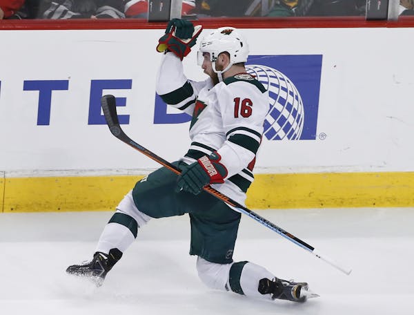 Minnesota Wild left wing Jason Zucker (16) celebrates a goal against the Chicago Blackhawks during the third period of an NHL hockey game Tuesday, Apr