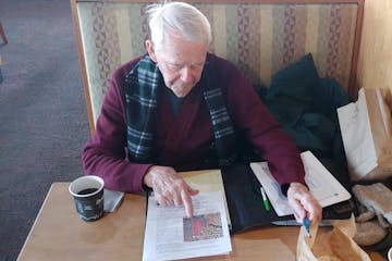 Jim White, former Orono mayor, reviews records of a city land deal that he and two other ex-mayors say was illegal.