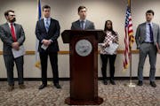Minneapolis Mayor Jacob Frey along with attorneys Tom Walsh, Clint Conner, Luke Grundman (far right) and resident Gina Robinson (right of mayor) durin