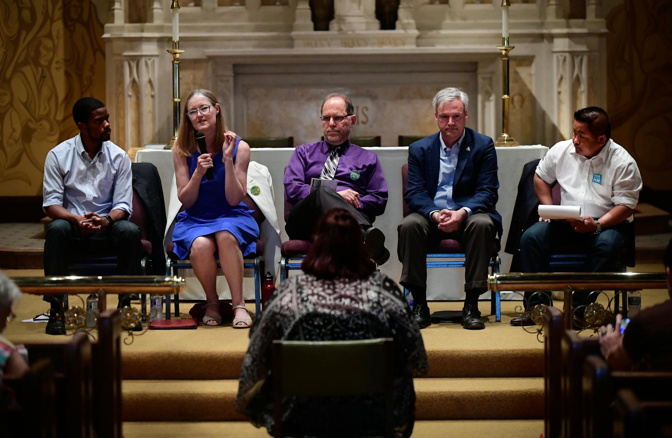 St. Paul mayoral candidates including, from left, Melvin Carter, Elizabeth Dickinson, Tom Goldstein, Pat Harris and Dai Thao, answered a question asked by Sumer Spika, bottom center, about their views on a $15 minimum wage during Tuesday night's mayoral forum. ] AARON LAVINSKY ï aaron.lavinsky@startribune.com St. Paul's mayoral candidates faced off Tuesday night at the final forum before Saturday's DFL convention. The frontrunners tried to distinguish themselves from the pack at tonight's e