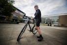 Robert Gay stands with his bike outside the Rainier Beach Community Center on Aug. 9, 2019. Gay, a novice cyclist, has partnered with Trips for Kids t