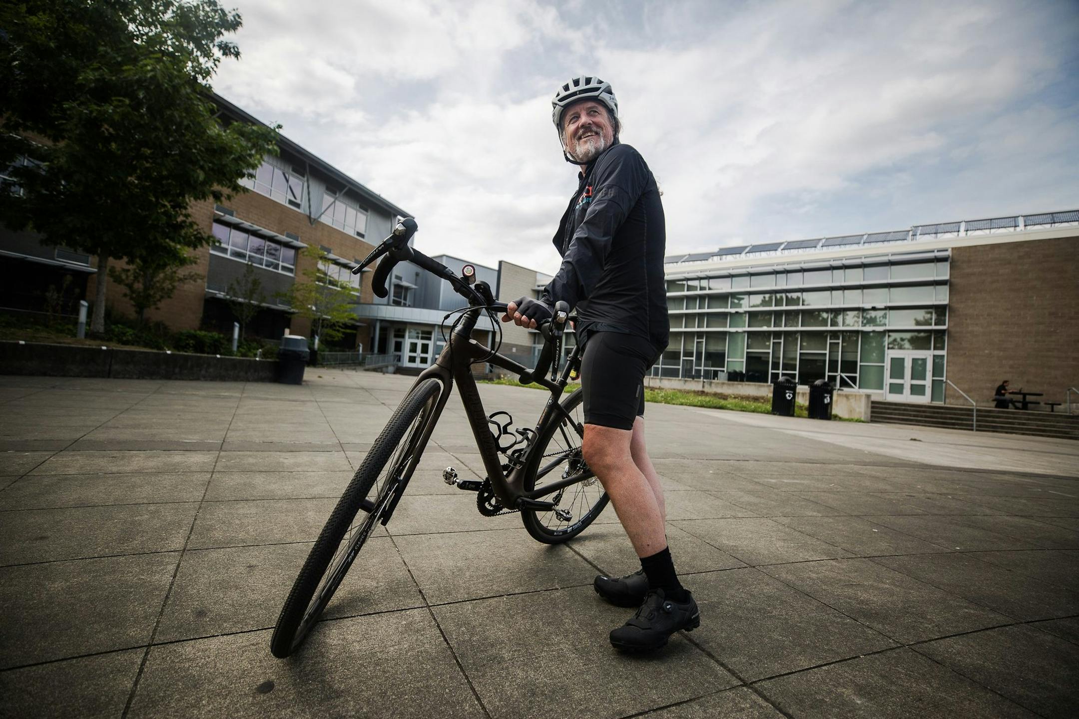 Robert Gay stands with his bike outside the Rainier Beach Community Center on Aug. 9, 2019. Gay, a novice cyclist, has partnered with Trips for Kids to raise aweness for the organization that provides bikes for kids in need, and is stopping along the way in cities with a chapter. (Rebekah Welch/Seattle Times/TNS) ORG XMIT: 1409948 ORG XMIT: MIN1909040335245920