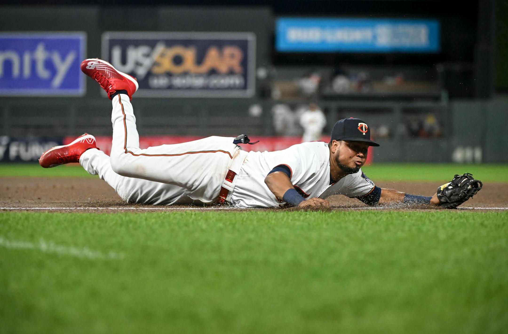Minnesota Twins first baseman Luis Arraez (2) leaps to catch an overthrown ball by second baseman Jorge Polanco (11) off a hit by New York Yankees second baseman Gleyber Torres (25) during the top of the 7th inning.