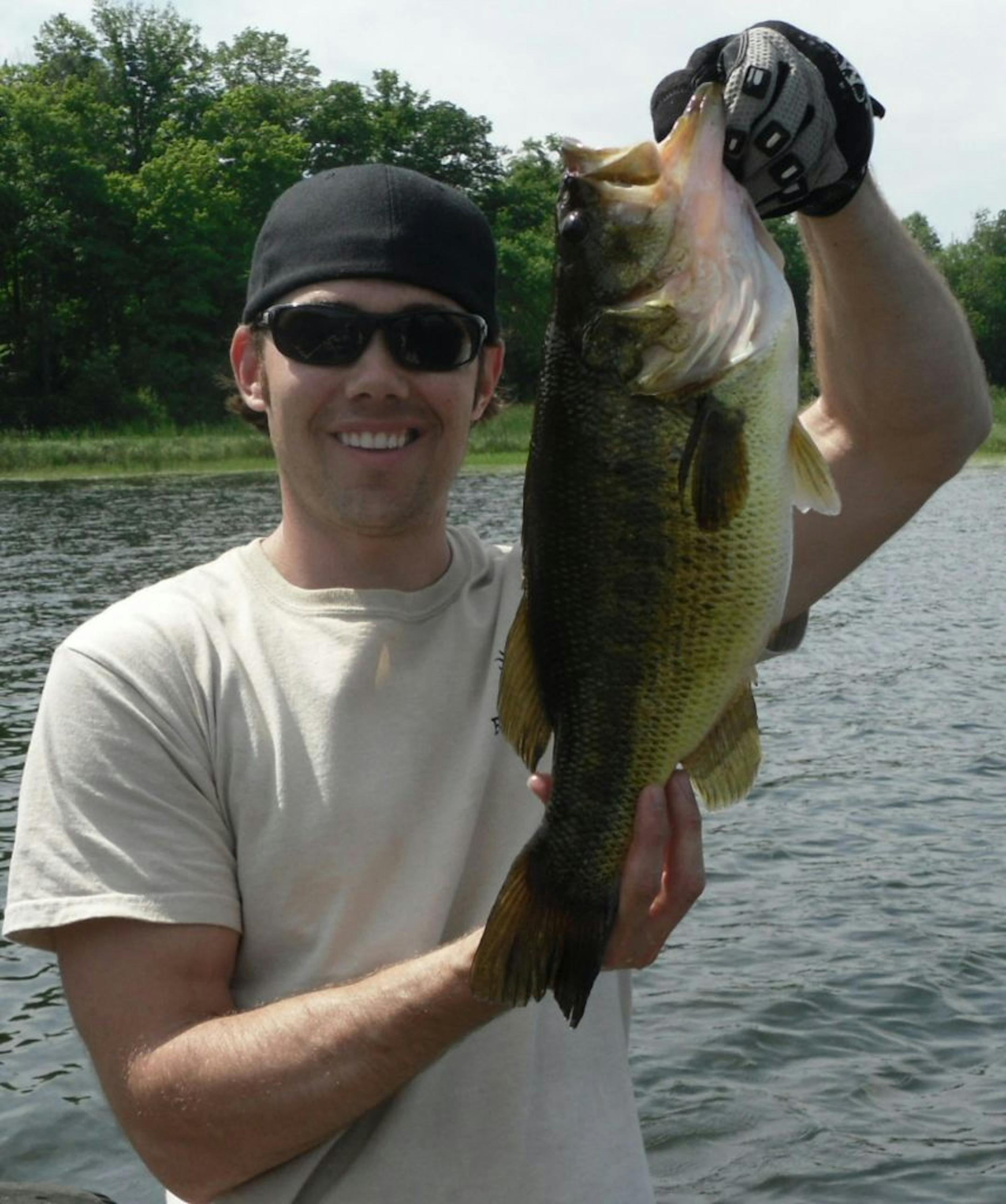 Big bucketmouth: Matthew Jacobs of Little Canada was fishing for muskies on Leech Lake when this 20-inch monster largemouth bass struck his 8-inch lure. "We couldn't believe how big he was when netted him,'' Jacobs said. "We released him right away for the next lucky angler!''