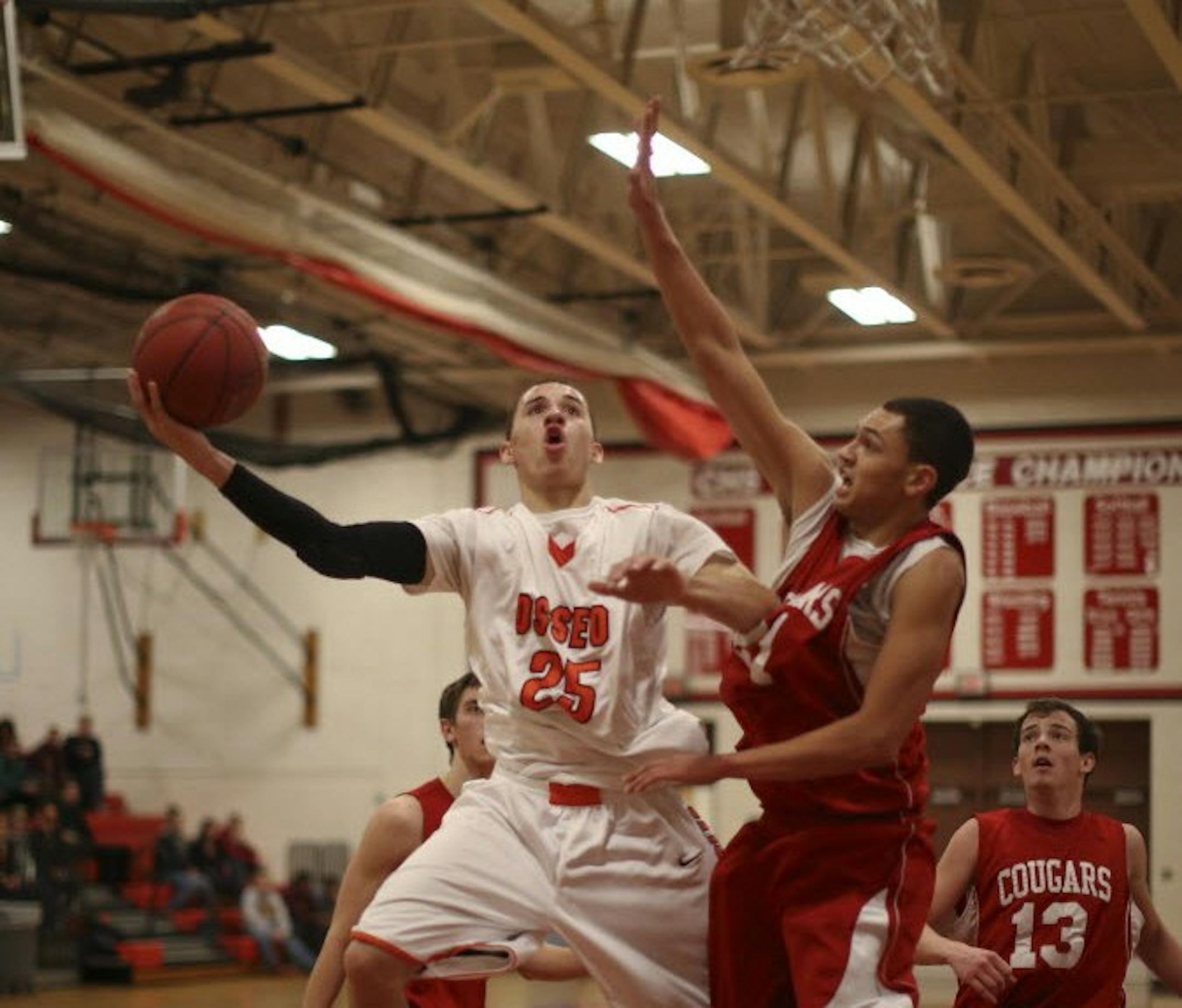 Osseo's Wheeler Baker drove past Centennial's Pierre Roddy on Thursday night in Circle Pines. Baker, a junior guard, scored a team-high 25 points as the defending Class 4A champions beat the Cougars 78-59. Photo by JEFF WHEELER • jwheeler@startribune.com