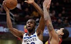 Minnesota Timberwolves' Andrew Wiggins (22) drives to the basket against Cleveland Cavaliers' Jordan Clarkson (8) in the second half of an NBA basketb