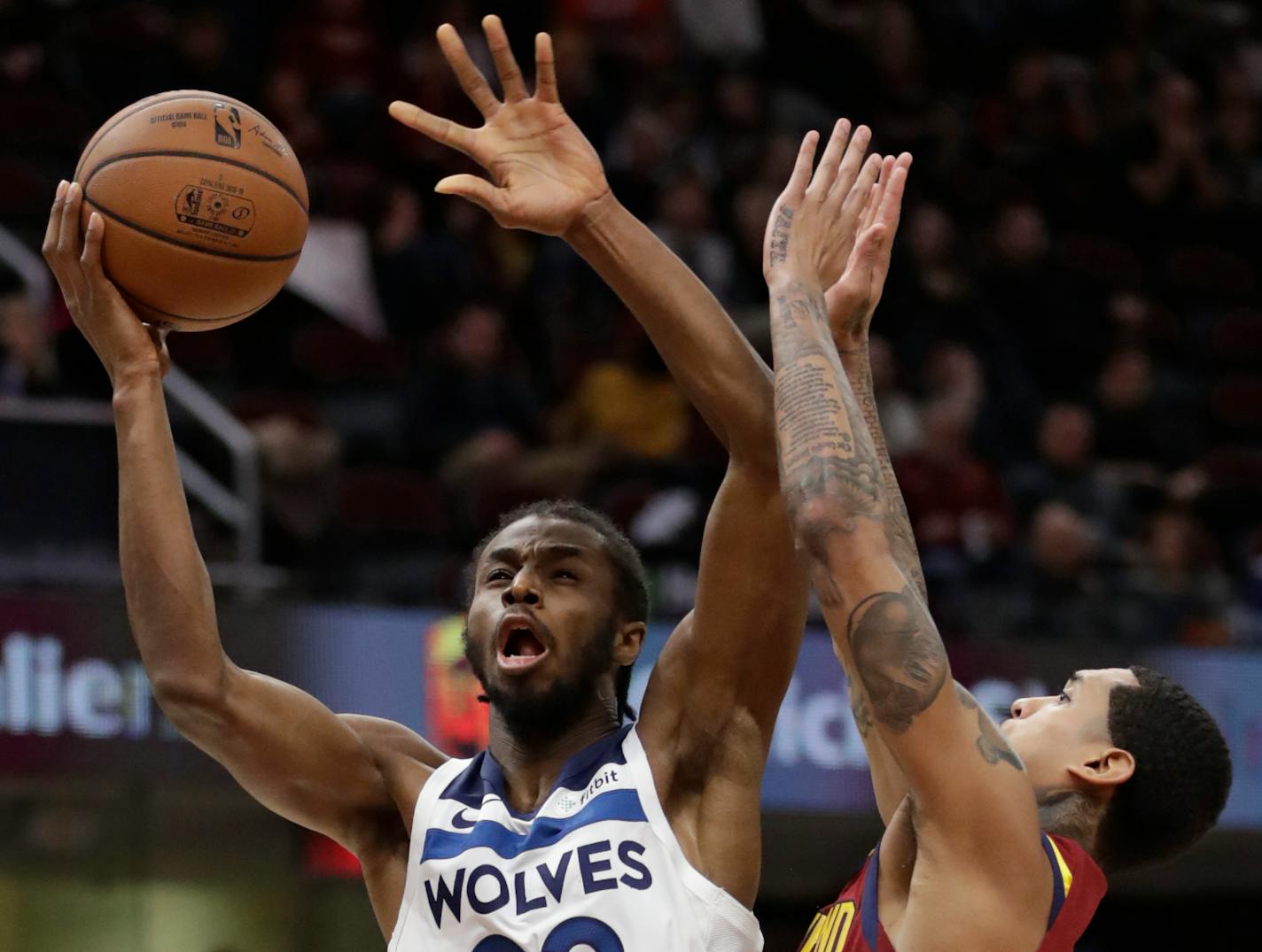 Minnesota Timberwolves' Andrew Wiggins (22) drives to the basket against Cleveland Cavaliers' Jordan Clarkson (8) in the second half of an NBA basketball game, Monday, Nov. 26, 2018, in Cleveland. (AP Photo/Tony Dejak)