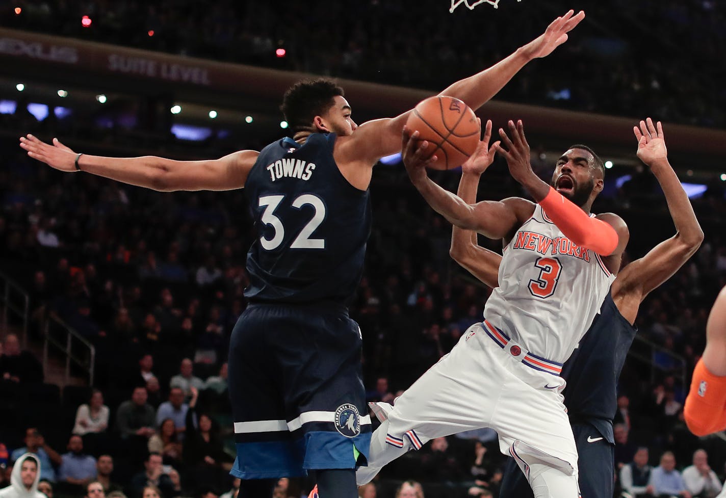 New York Knicks forward Tim Hardaway Jr. (3) shoots against Minnesota Timberwolves center Karl-Anthony Towns (32) and forward Andrew Wiggins (22) during the fourth quarter of an NBA basketball game, Friday, March 23, 2018, in New York. (AP Photo/Julie Jacobson)